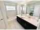 Bathroom with double vanity, bathtub and marble tile at 962 Splash Shot Pl, Davenport, FL 33896