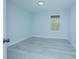 Spacious bedroom with light gray floors and a window at 1146 Atlantic Ave, Fruitland Park, FL 34731