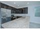 Modern kitchen featuring granite countertops and stainless steel appliances at 1146 Atlantic Ave, Fruitland Park, FL 34731