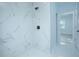 Large walk-in shower with marble tile and modern fixtures at 1146 Atlantic Ave, Fruitland Park, FL 34731
