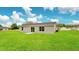 Spacious backyard with grassy lawn, perfect for outdoor activities at 297 Malauka Run, Ocklawaha, FL 32179