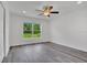 Bright bedroom with ceiling fan and gray vinyl flooring at 297 Malauka Run, Ocklawaha, FL 32179