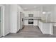 Modern kitchen with white cabinets, granite counters and stainless steel appliances at 297 Malauka Run, Ocklawaha, FL 32179