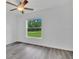 Bedroom with ceiling fan and large window at 297 Malauka Run, Ocklawaha, FL 32179