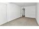 Simple bedroom with neutral carpeting and an open door at 448 Nw 18Th Ave, Ocala, FL 34475