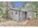 Gray house exterior with surrounding trees at 448 Nw 18Th Ave, Ocala, FL 34475
