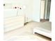 Spacious bedroom with a dresser and a comfortable double bed at 4146 Versailles Dr # 4146D, Orlando, FL 32808