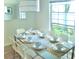 Modern dining room with a glass-top table and seating for eight at 4146 Versailles Dr # 4146D, Orlando, FL 32808