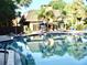 Community pool with clubhouse, lounge chairs and hot tub at 4146 Versailles Dr # 4146D, Orlando, FL 32808
