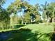 Expansive green lawn with mature trees at 4146 Versailles Dr # 4146D, Orlando, FL 32808