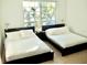 Spacious bedroom with two double beds, offering comfort and ample natural light at 4146 Versailles Dr # 4146D, Orlando, FL 32808