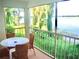 Spacious screened balcony with table and chairs overlooking the lake at 4146 Versailles Dr # 4146D, Orlando, FL 32808