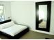 Bright bedroom with a double bed and a large mirror, maximizing space and light at 4146 Versailles Dr # 4146D, Orlando, FL 32808
