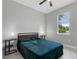 Bright bedroom with a teal comforter and window at 370 Routh Ave, New Smyrna Beach, FL 32168