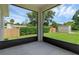 Screened porch overlooking backyard and trees at 370 Routh Ave, New Smyrna Beach, FL 32168