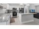 Modern kitchen with stainless steel appliances and breakfast bar at 370 Routh Ave, New Smyrna Beach, FL 32168