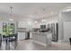 Open concept kitchen features an island and stainless steel appliances at 370 Routh Ave, New Smyrna Beach, FL 32168