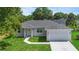 Single-story home with attached garage and landscaped lawn at 370 Routh Ave, New Smyrna Beach, FL 32168