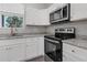 Modern kitchen with granite countertops and stainless steel appliances at 370 Routh Ave, New Smyrna Beach, FL 32168