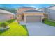 Two-story house with brown garage door and landscaping at 1146 Atlantic Ave, Fruitland Park, FL 34731