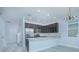 Open concept kitchen with dark cabinetry and granite countertops at 1146 Atlantic Ave, Fruitland Park, FL 34731