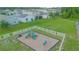 Aerial view of a playground with a slide and climbing structure, enclosed by a white fence at 1146 Atlantic Ave, Fruitland Park, FL 34731