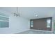 Bright dining room with modern chandelier and wood-look floors at 1146 Atlantic Ave, Fruitland Park, FL 34731
