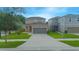 Two-story house with brown garage door and landscaping at 1146 Atlantic Ave, Fruitland Park, FL 34731