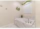 Elegant bathroom with a soaking tub and marble tile surround at 4562 Narrative Ln, Kissimmee, FL 34746