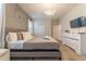 King-size bed, large bedroom with lots of natural light and a dresser at 4562 Narrative Ln, Kissimmee, FL 34746