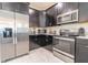 Modern kitchen with stainless steel appliances and dark cabinetry at 4562 Narrative Ln, Kissimmee, FL 34746