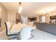 Bright dining room with large table and seating for six, open to living area at 4562 Narrative Ln, Kissimmee, FL 34746