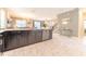 Modern kitchen with island, stainless steel appliances, and white tile floors at 4562 Narrative Ln, Kissimmee, FL 34746