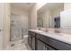 Modern bathroom with double vanity and a large walk-in shower at 4562 Narrative Ln, Kissimmee, FL 34746
