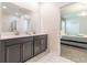 Double vanity bathroom with a view into a bedroom at 4562 Narrative Ln, Kissimmee, FL 34746