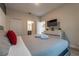 Bright bedroom with a king-size bed and a flat-screen TV at 4562 Narrative Ln, Kissimmee, FL 34746