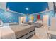 Toy Story themed bedroom with three twin beds and blue cloud walls at 4562 Narrative Ln, Kissimmee, FL 34746
