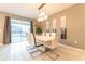 Modern dining room with white table and chairs, and geometric wall art at 4562 Narrative Ln, Kissimmee, FL 34746