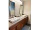 Double vanity bathroom with granite countertop and large mirrors at 1393 Beverly Ln, Casselberry, FL 32707