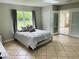 Bright bedroom with tiled floors and sliding glass doors leading to the backyard at 1393 Beverly Ln, Casselberry, FL 32707