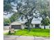 Newly renovated single story home with a spacious lawn and mature trees at 1393 Beverly Ln, Casselberry, FL 32707
