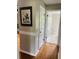 Light and airy hallway with hardwood floors and neutral decor at 1393 Beverly Ln, Casselberry, FL 32707