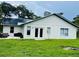 Home with solar panels, a patio, and a grassy backyard at 1393 Beverly Ln, Casselberry, FL 32707
