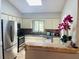 Bright kitchen featuring stainless steel appliances and a breakfast bar at 1393 Beverly Ln, Casselberry, FL 32707