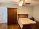 Bedroom with hardwood floors, a large wardrobe, and a double bed at 1393 Beverly Ln, Casselberry, FL 32707