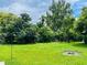 Spacious backyard with green grass and a bird feeder at 1393 Beverly Ln, Casselberry, FL 32707