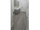 Laundry room with gray cabinets and wood-look flooring at 555 Sanctuary Golf Pl, Apopka, FL 32712