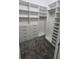 Bright walk-in closet featuring built-in shelves and drawers at 555 Sanctuary Golf Pl, Apopka, FL 32712