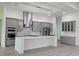 Modern kitchen with gray cabinets, white countertops, and stainless steel appliances at 555 Sanctuary Golf Pl, Apopka, FL 32712