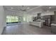 Open floor plan kitchen with island, stainless steel appliances, and gray cabinets at 555 Sanctuary Golf Pl, Apopka, FL 32712